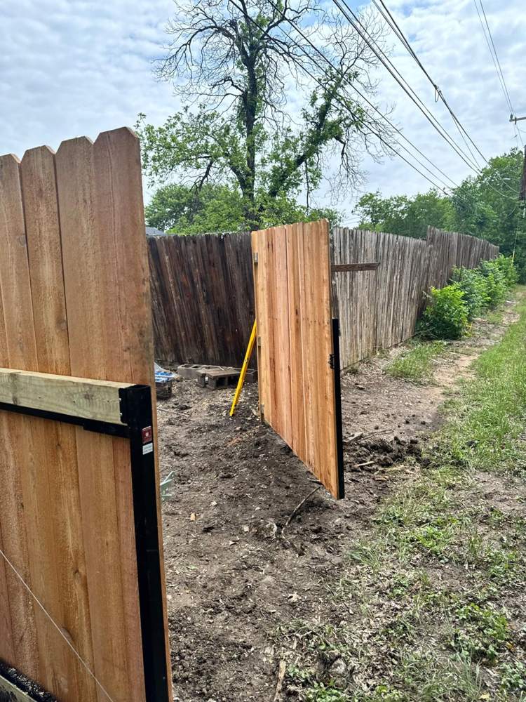 New cedar gate on a steel frame next to an old weathered fence