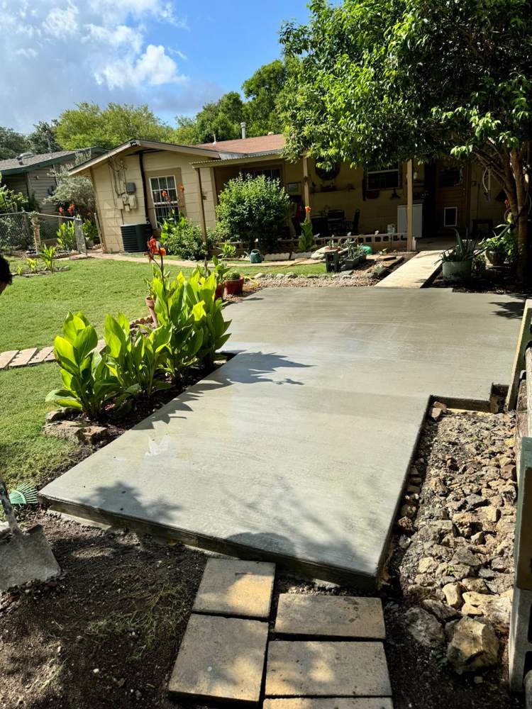 Finished backyard patio slab between garden beds