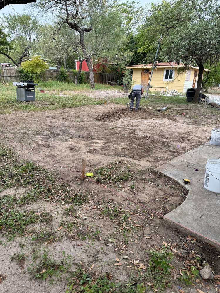 Crew clearing and leveling ground for a slab