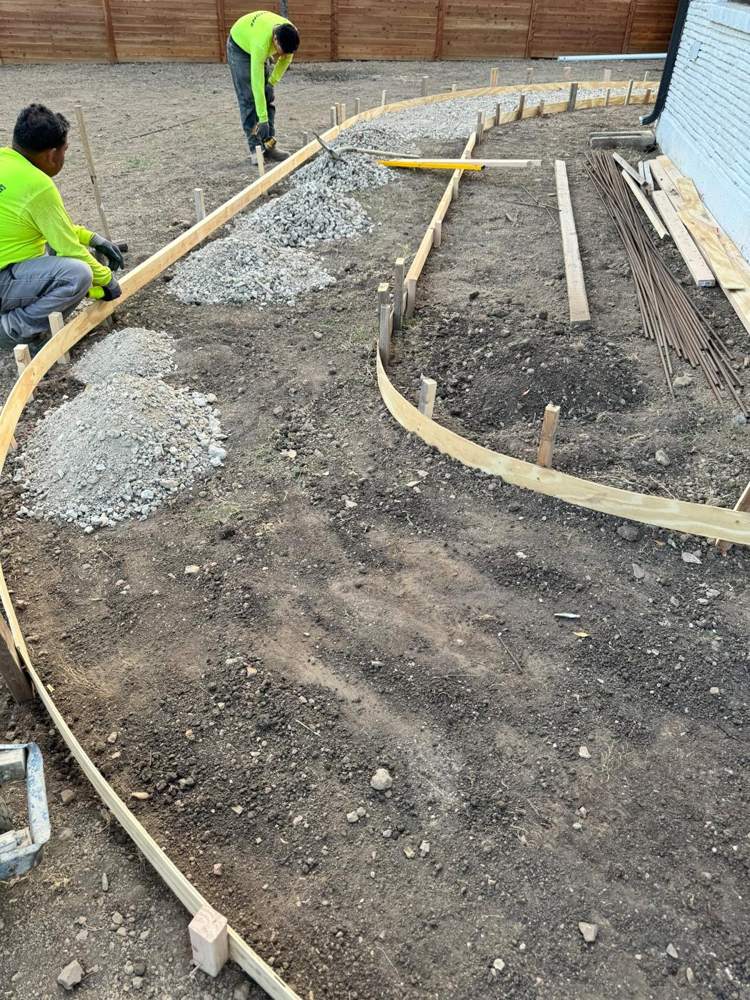 Crew setting curved wood forms for a sidewalk